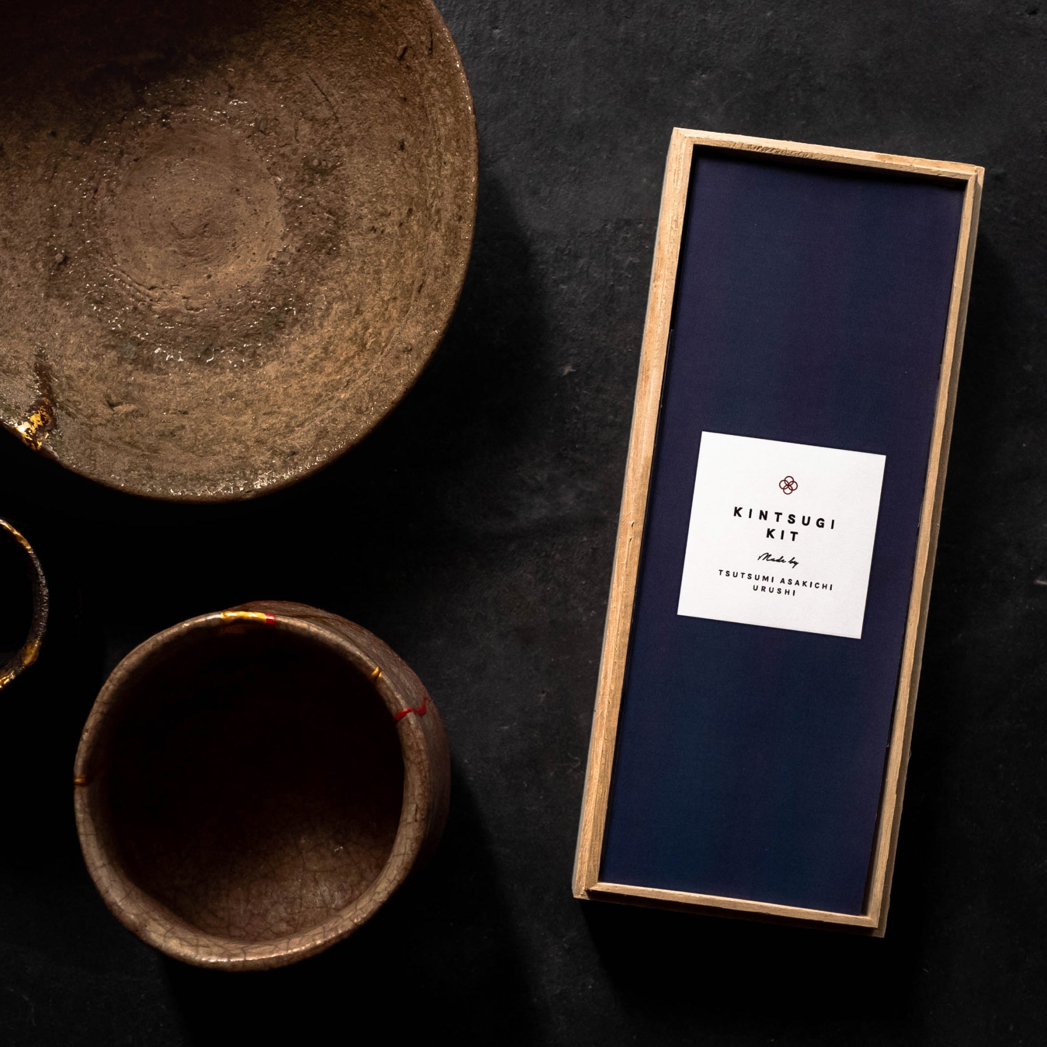 Pottery with golden kintsugi application and our kintsugi kit next to it