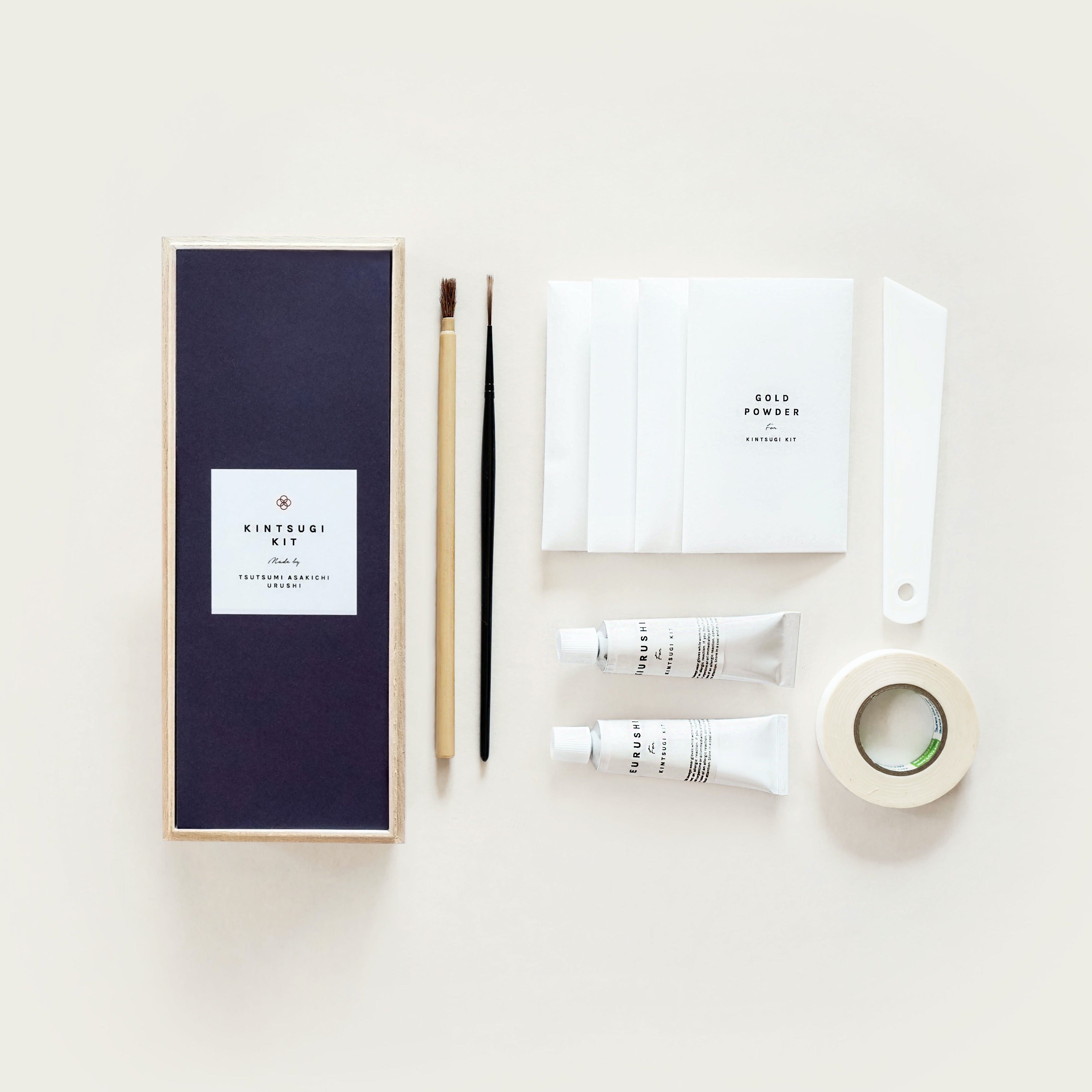 Our Kintsugi kit two types of urushi, tonoko and gold powder, sand paper, gloves, two brushes, tape and a spatula